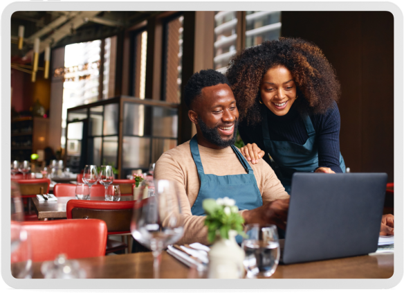 man and woman looking at a laptop